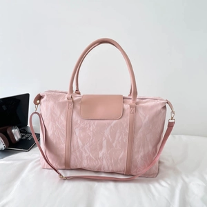 Pink large travel tote bag with pleated texture, dual handles and adjustable shoulder strap