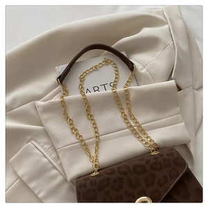 Detail of leopard print suede shoulder bag with gold chain strap and ring closure
