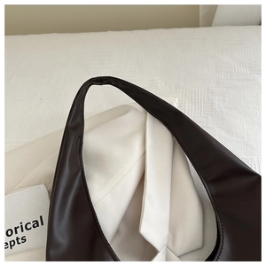 Detailed close-up of dark brown PU leather shoulder strap with neat stitching on tote bag