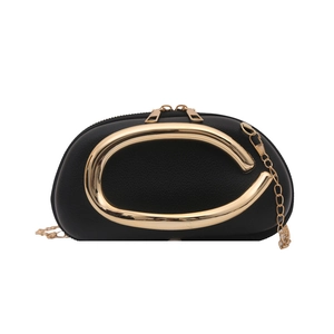 Modern black leather crossbody box bag with gold C-handle and chain strap on white background
