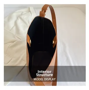 Internal structure of brown bucket bag showing black lining and gold magnetic closure