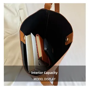 Interior view of large brown leather tote bag with magnetic closure and storage space