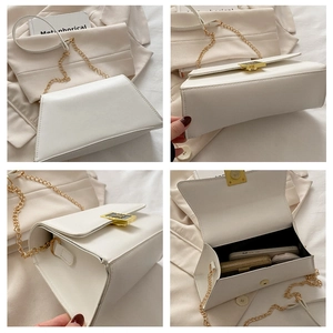 Detail view of large white PU leather bag with gold buckle and spacious inner compartment