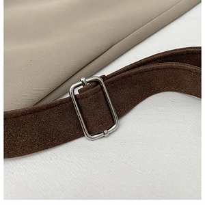 Close-up of adjustable dark brown suede shoulder strap with silver metal buckle detail