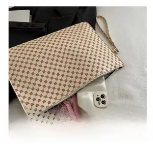 Detail showing inner storage of printed clutch bag holding smartphone and card holder