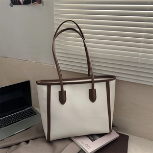 Minimalist cream tote bag with brown trim and large capacity for daily commuting