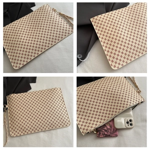 Detail view of printed floral envelope clutch with golden zipper and interior storage capacity