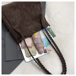 Detail view of brown matte tote bag showing large capacity for tablet and cosmetics
