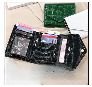 Detail showing the internal layout of three-fold crocodile texture wallets in three colors