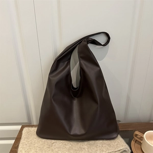 Minimalist large dark brown tote bag in soft leather with a relaxed slouchy shoulder design