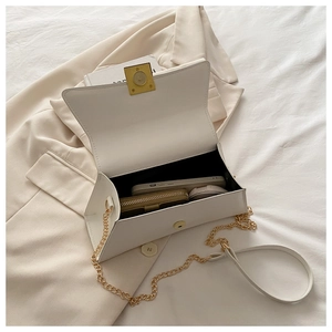 Top view of white PU leather crossbody bag open showing interior storage and gold chain