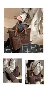 Detail view of leopard print tote bag with small matching pouch and leather handles