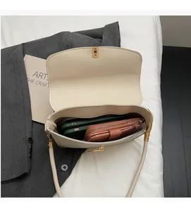 Top view of cream shoulder bag interior showing capacity for two phones and a wallet