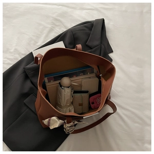 Detailed top view of a brown tote bag showing large capacity for laptop and umbrella
