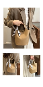 Detailed view of camel leather bucket bag with elegant polka dot silk scarf handle