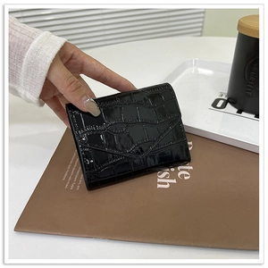 Close-up of black crocodile-pattern faux leather business envelope clutch for women