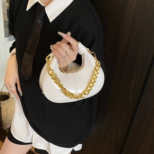 Chic white mini moon bag with glossy finish and gold chain handle shown on model