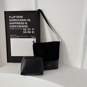 Minimalist black two-piece bucket bag set with shoulder strap and matching pouch