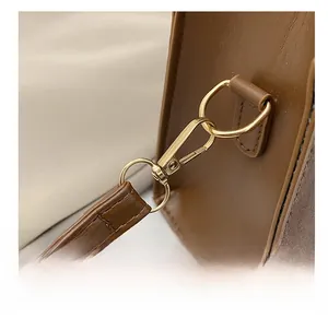 Close-up of golden hardware and shoulder strap hook on the brown leopard bowling bag