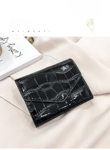 Detail shot of black crocodile embossed faux leather card holder with envelope flap design