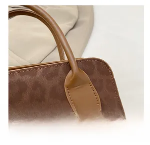 Close-up of the vintage handbag showing premium stitching and textured brown leather