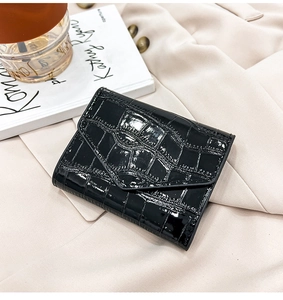Close-up of black crocodile pattern wallet on a suit with artistic lifestyle props