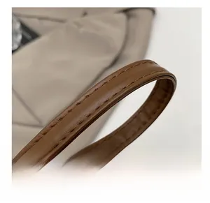 Macro shot of durable brown PU leather shoulder strap with high-quality stitching details