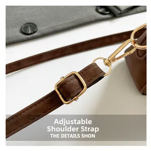 Macro shot of dark brown leather adjustable shoulder strap with golden metal buckle