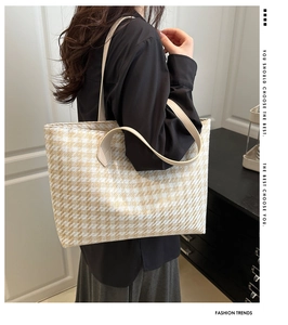 Detail of classic beige houndstooth woven fabric on a large capacity tote shoulder bag