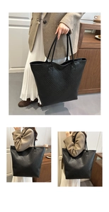 Detail of a black woven leather tote bag showing large capacity and fine texture