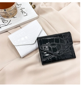Detailed close-up of glossy crocodile texture mini card holders in black and white