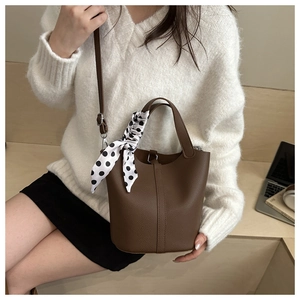 Deep brown lychee pattern leather bucket bag with silk scarf on handle and shoulder strap