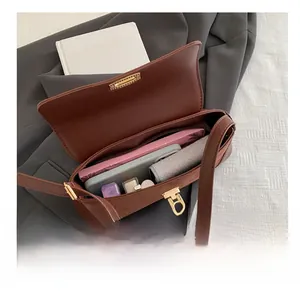 Detail view of brown suede shoulder bag showing spacious interior for daily essentials