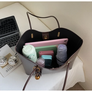 Detailed view of dark brown tote bag interior showing large capacity for daily items