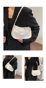 Detail view of cream hobo underarm bag showing gathered leather texture and shoulder strap