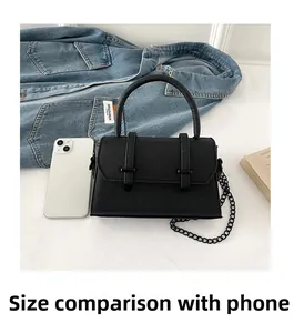 Mini black PU leather flap bag shown next to a smartphone for size comparison