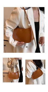 Detail view of a minimalist brown hobo underarm bag showing leather texture and sleek design