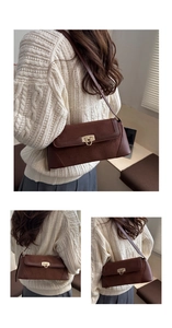 Detail of vintage brown shoulder bag with golden lock on a model in beige sweater