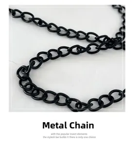 Detail shot of the matte black hardware chain with interlocking metal links on bag