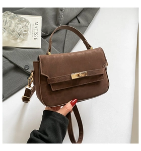 Detail of vintage brown crossbody bag with high-quality matte leather and gold twist lock