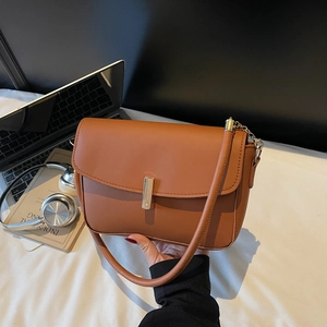 Brown leather rectangular shoulder bag with golden metallic clasp and chain strap