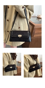 Detail of black leather and suede crossbody bag with gold round knob metal lock