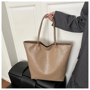Detail of khaki tote bag featuring premium woven texture and large capacity design