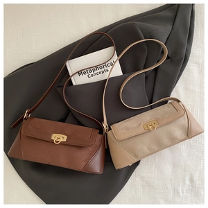 Detailed view of vintage crossbody bags in brown and apricot with metallic buckle