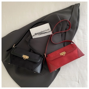 Detail of red and black baguette bags with suede patchwork and gold round swivel locks