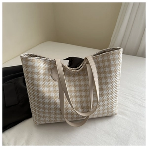 Close-up of the beige and khaki houndstooth woven texture on a large tote bag