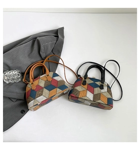 Detail of vintage geometric patchwork boston bag with colorful leather texture and handles