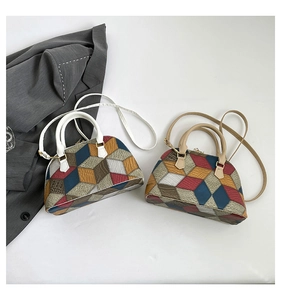 Detail view of colorful geometric patchwork pattern on stylish shell crossbody bag