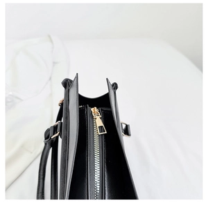 Dettaglio borsa in pelle PU nera con zip in metallo dorato e fibbie quadrate eleganti