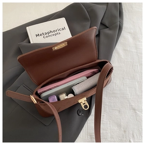 Top view of brown leather bag interior showing large capacity for essentials